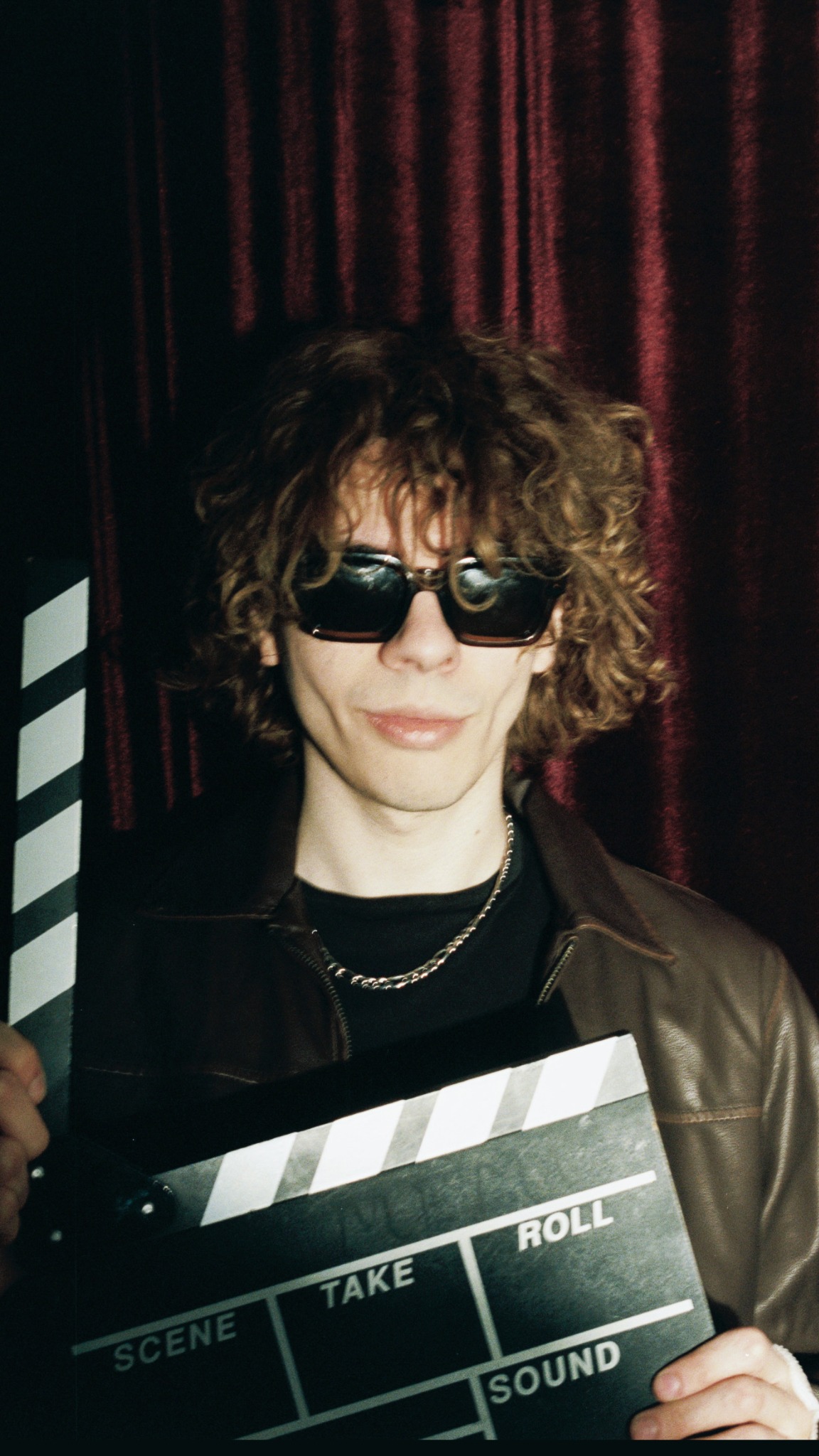 Caner Oz holding a clapperboard