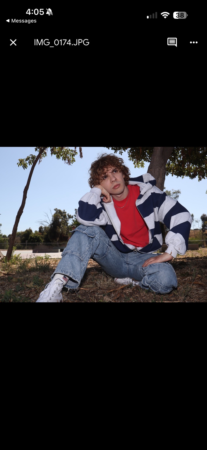 Caner Oz wearing a striped hoodie and baggy jeans at the skatepark