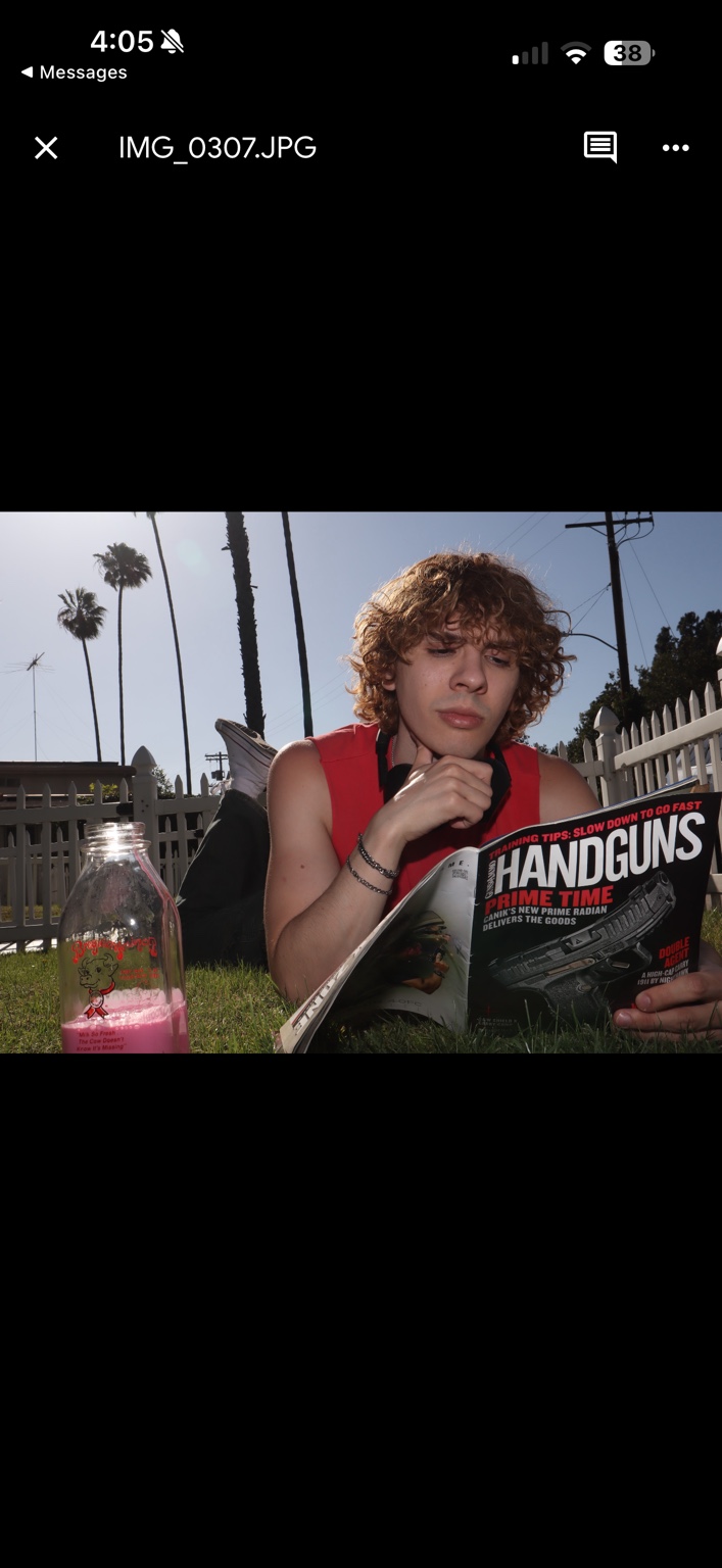 Caner Oz reading a magazine on the grass